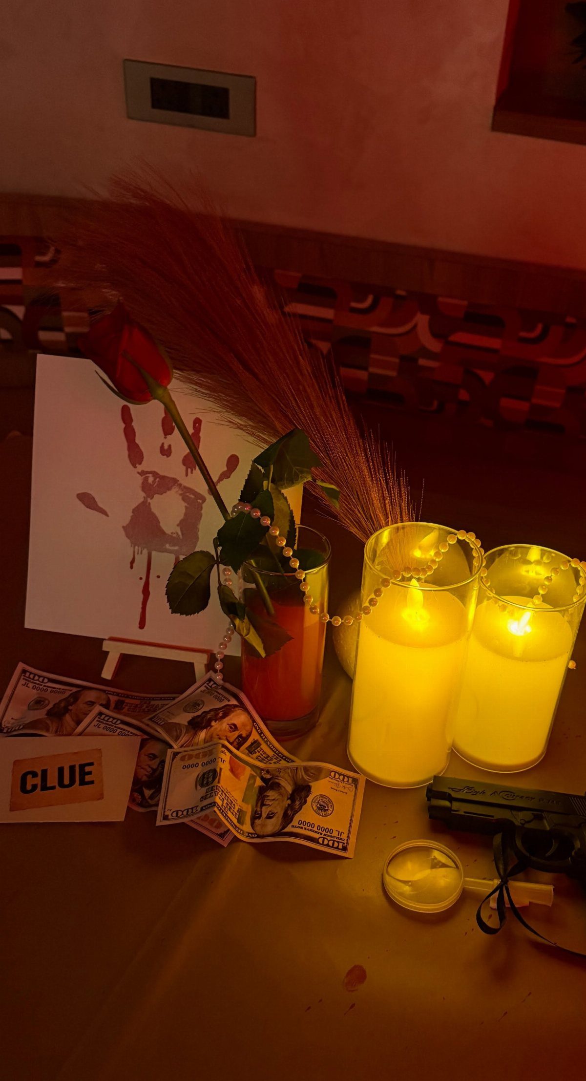 Mystery game table setup with clue card, toy gun, and glowing candles