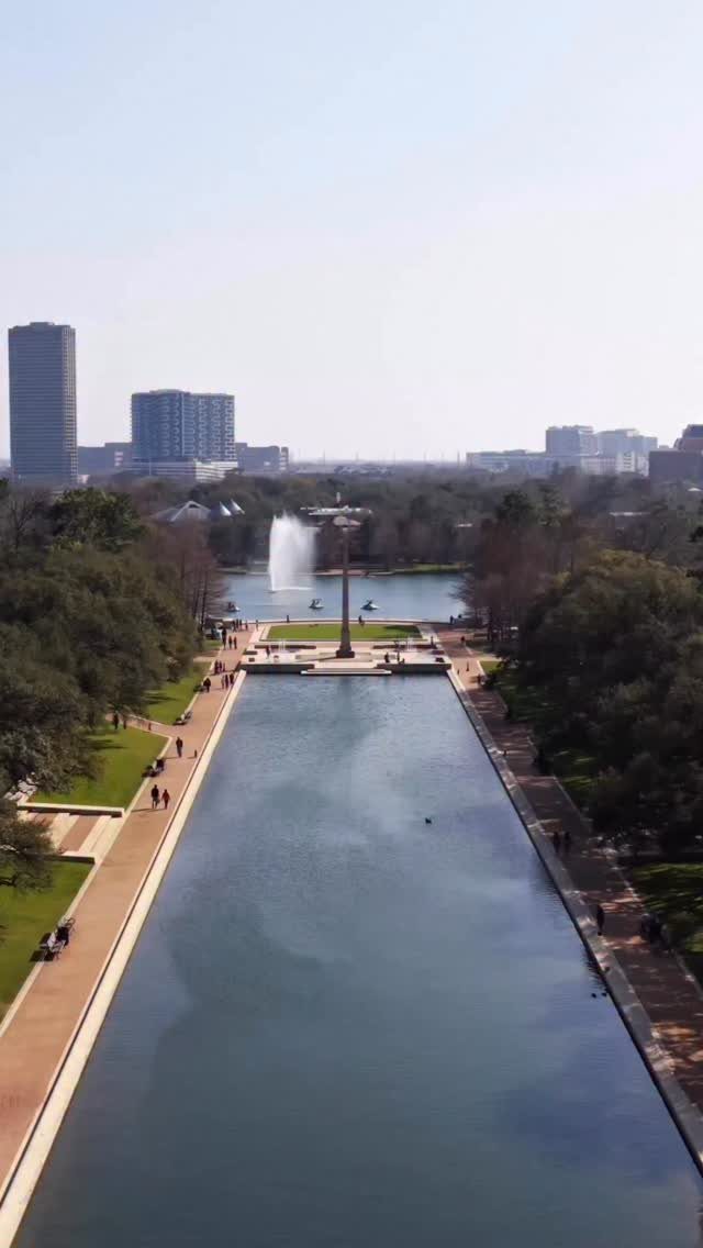 Reflecting pool and city skyline at Hermann Park in Houston, Texas