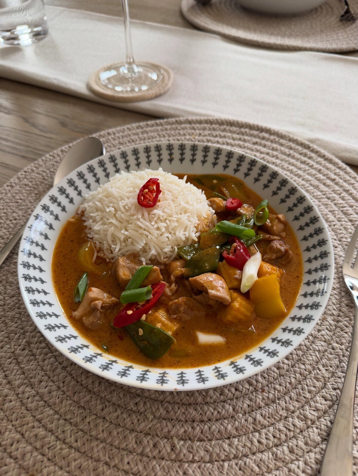 Thai beef curry with white rice, potatoes, and chilies in a patterned bowl.