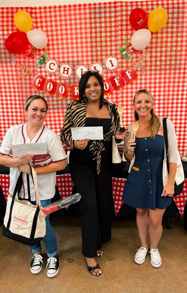 Three women posing with awards in front of a Chili Cook Off banner.