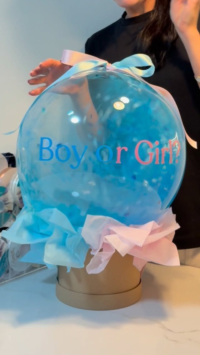 Gender reveal balloon filled with blue balloons and 'Boy or Girl?' text.