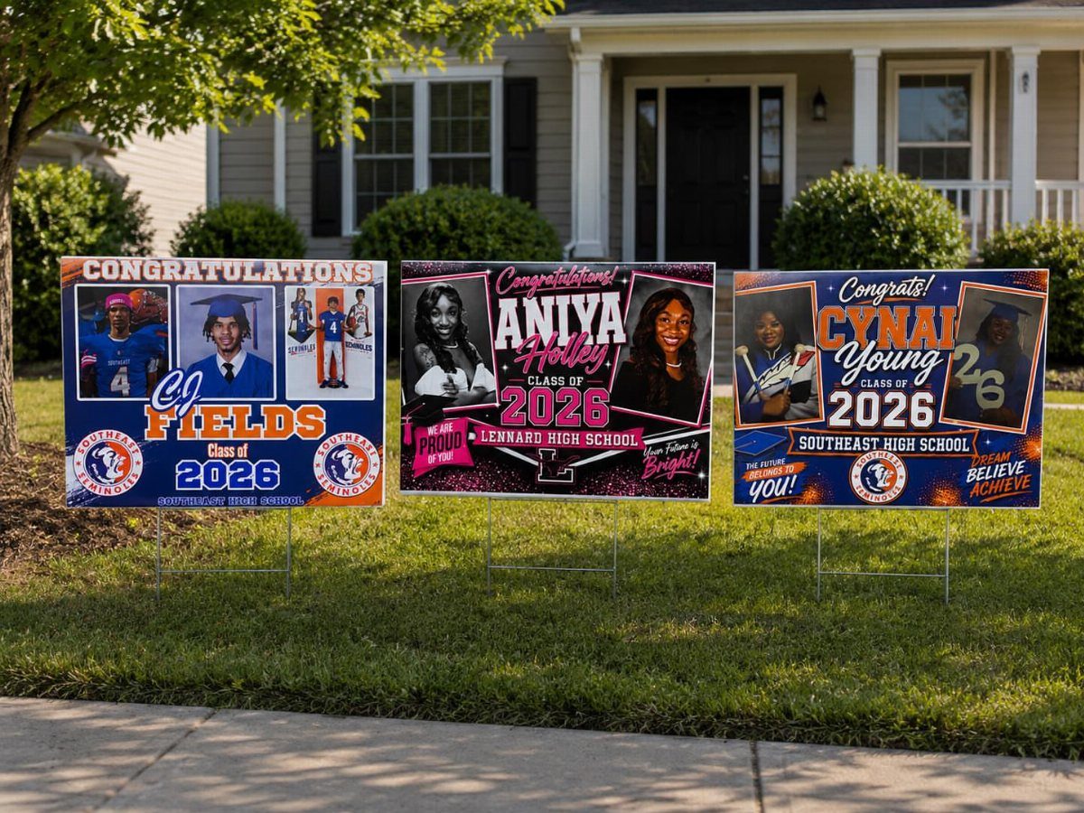 Three personalized graduation yard signs with student photos placed on a green lawn.