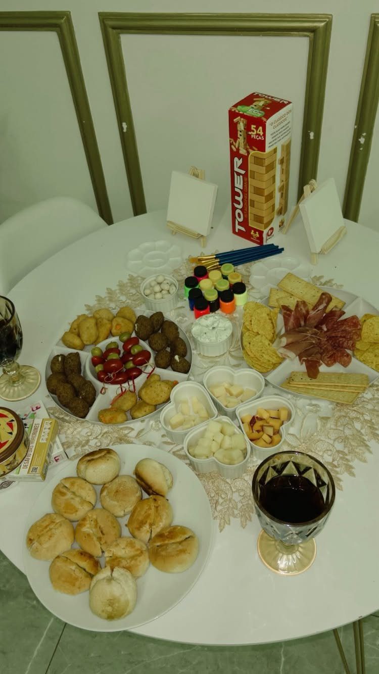 Appetizer platters and a Jenga game box arranged on a white round table.