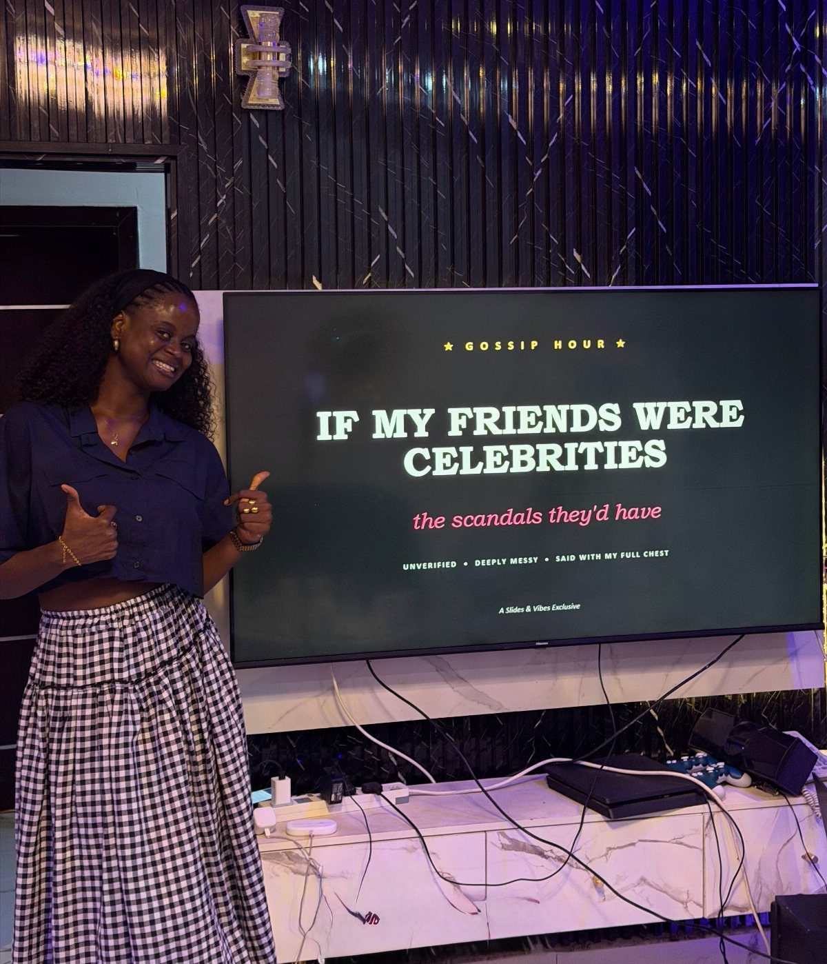 Woman standing beside a television screen showing a funny presentation about her friends.