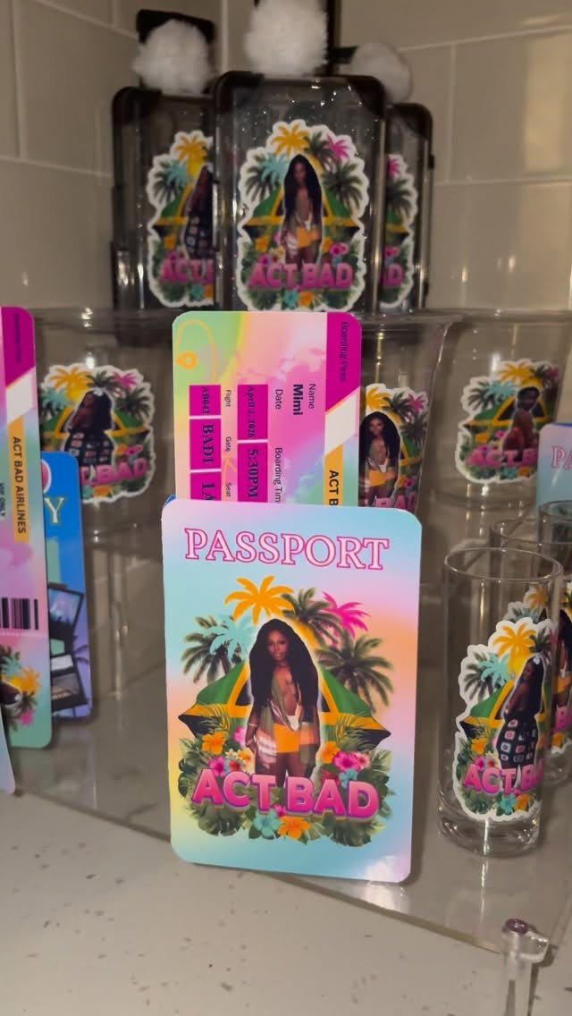 Custom tropical themed party favors including passports, boarding passes, and glasses on a shelf.