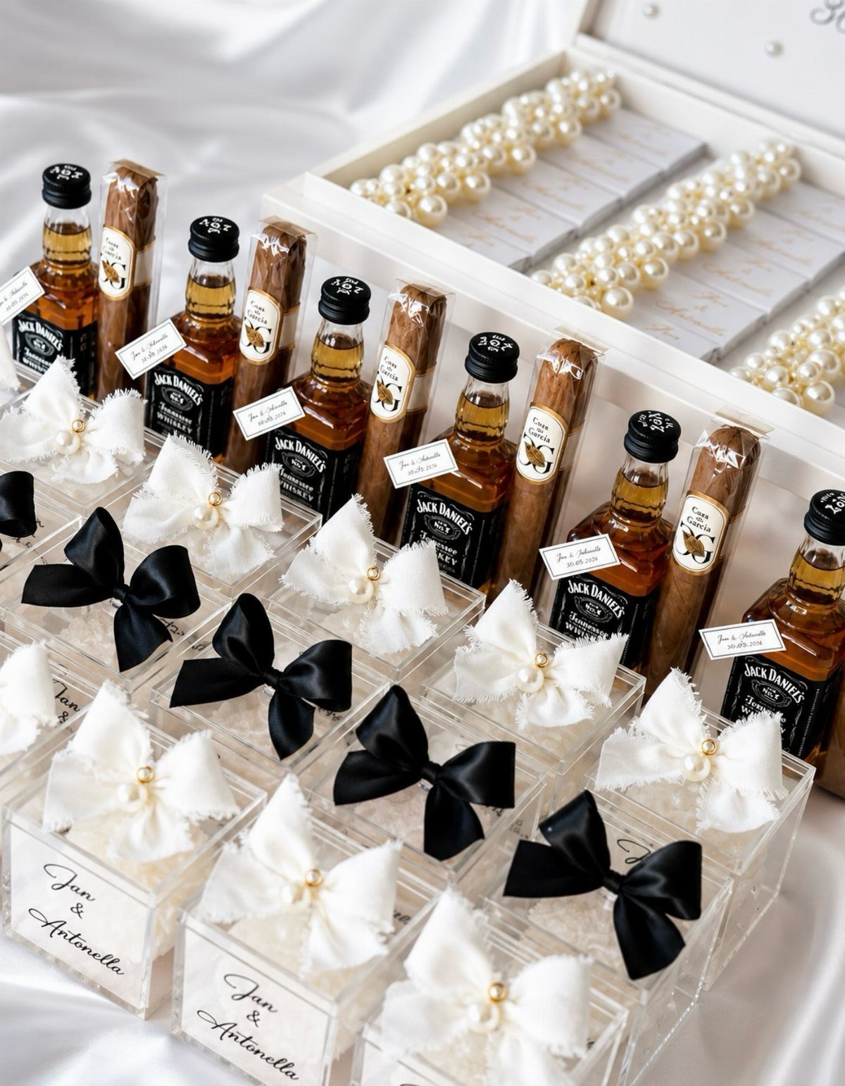 Miniature whiskey bottles and cigars in gift boxes with elegant black and white bows.