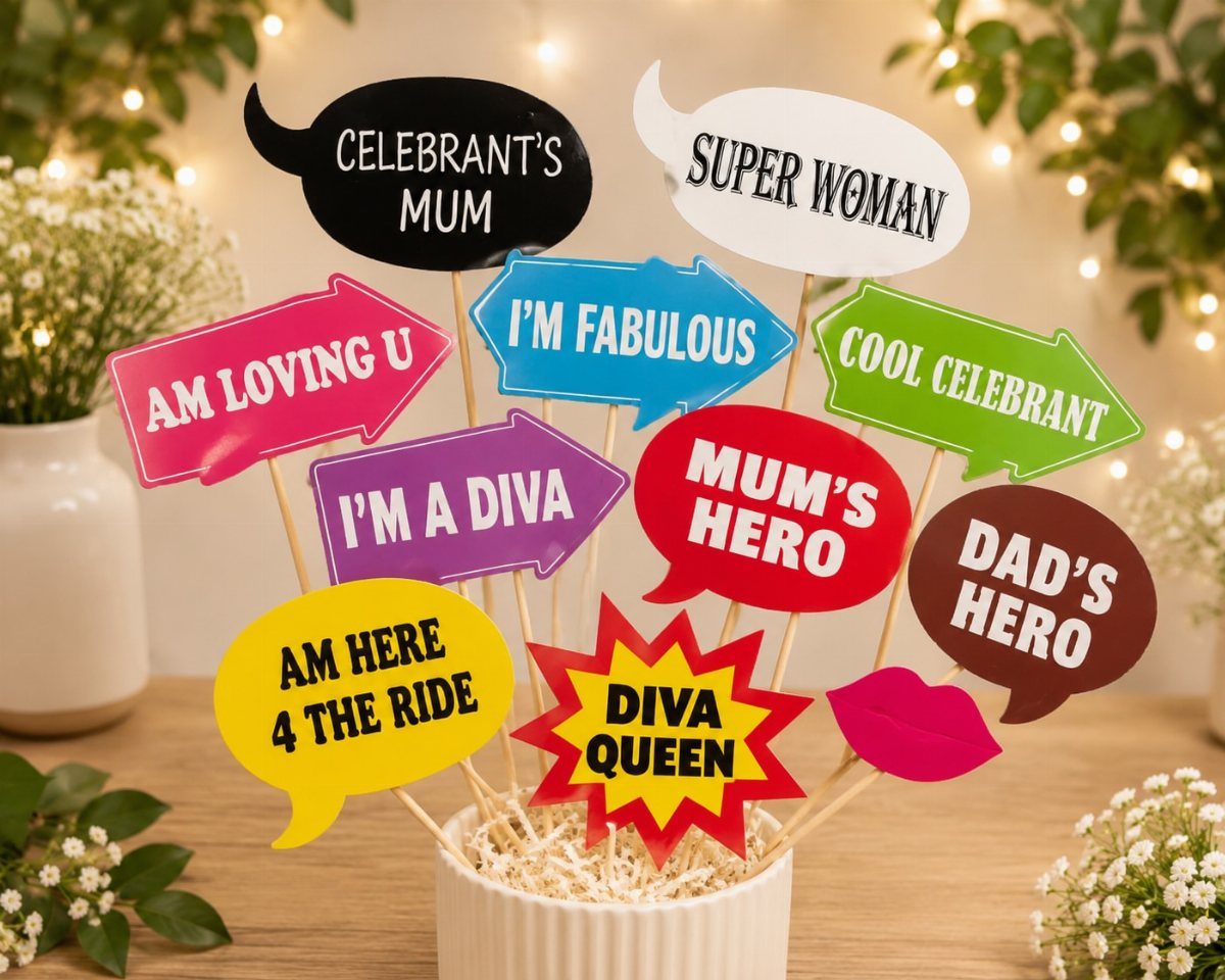 Colorful speech bubble photo booth props and red lips in a white pot.