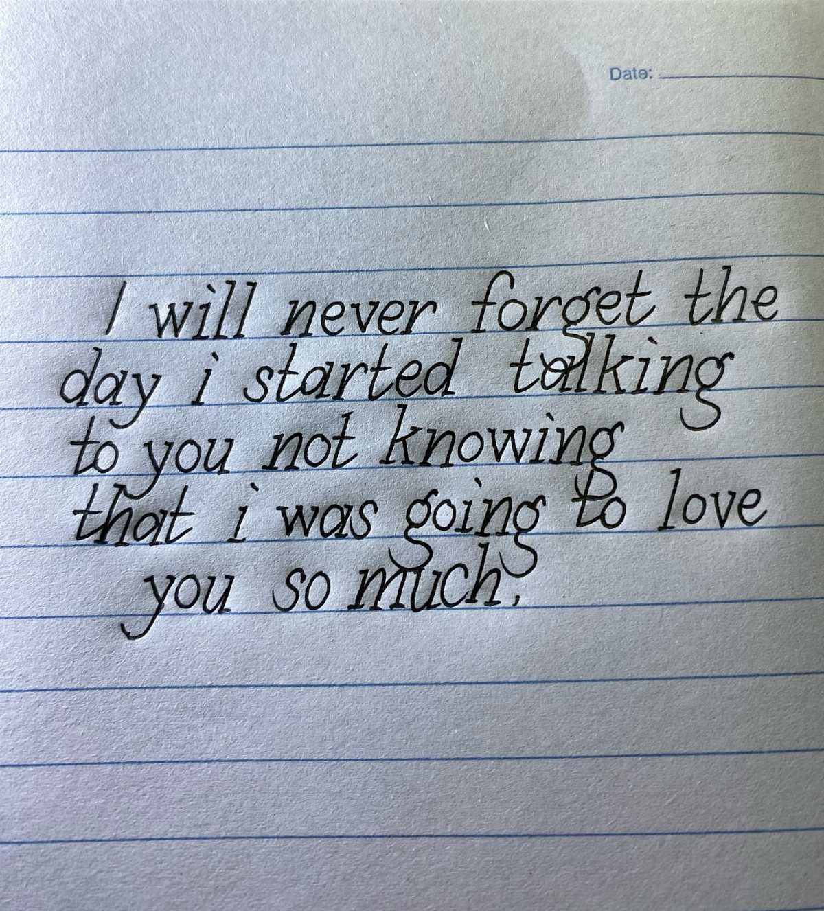 Handwritten love letter on lined notebook paper expressing deep affection in cursive ink.