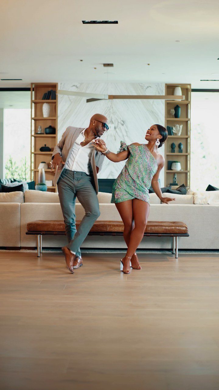 Couple dancing together in a modern living room during a romantic date.
