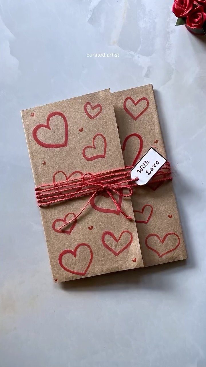 Hand-drawn red hearts on brown envelopes tied with red twine and love tag.