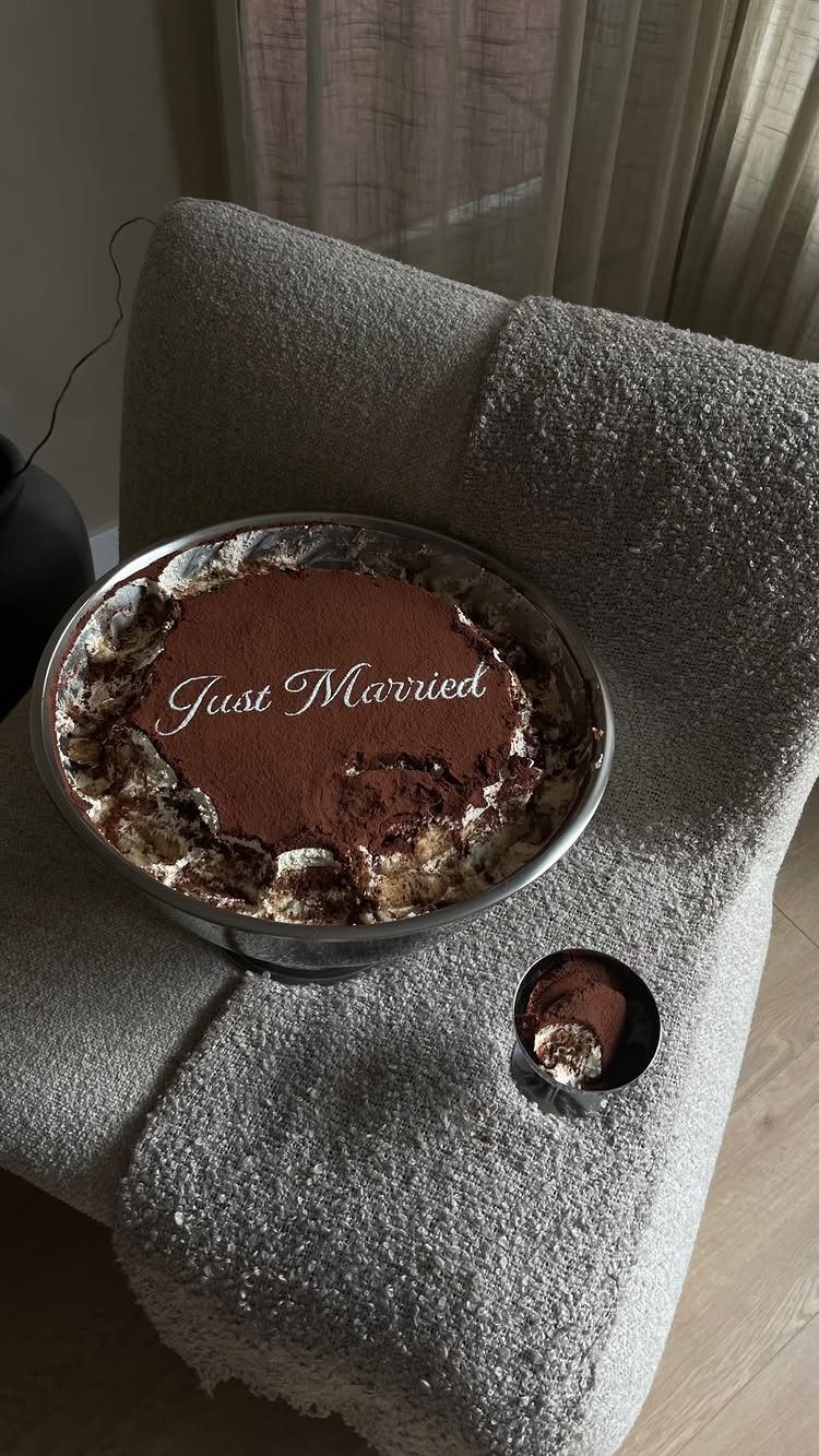 Tiramisu dessert in a glass bowl with Just Married written in white icing.