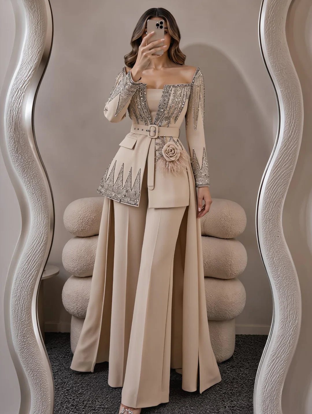 Woman in a beige sequined pantsuit with wide-leg trousers taking a mirror selfie.